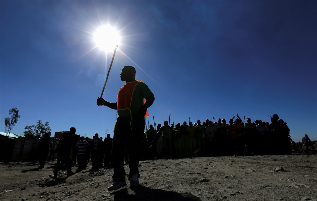 Miners commemorate the one-year anniversary of the killings of 34 striking platinum miners shot dead by police outside Lonmin's Marikana platinum mine in Rustenburg. Picture: Siphiwe Sibeko/Reuters