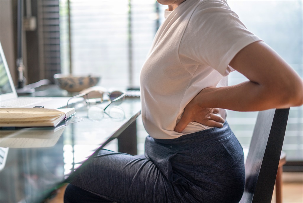 Woman suffering from back pain. (Boonchai Wedmakawand/Getty Images)