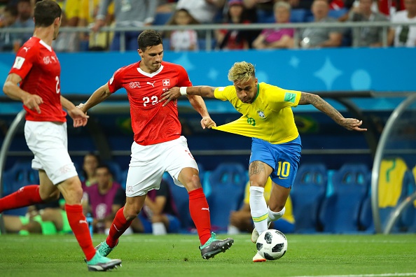 Fabian Schaer of Switzerland challenges Neymar of Brazil during the 2018 FIFA World Cup Russia group E 