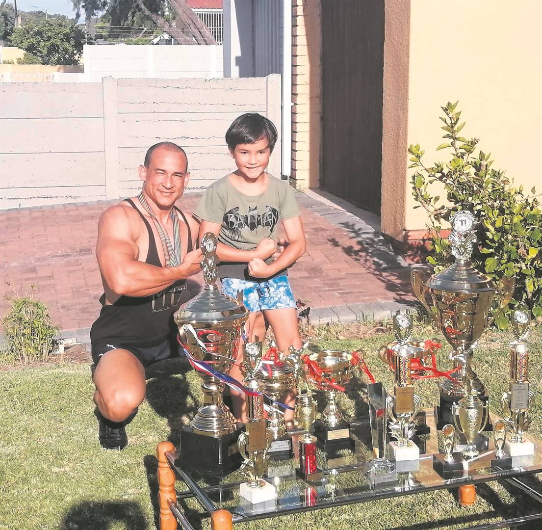 Kurt Smith and his son Jamie with his trophies.