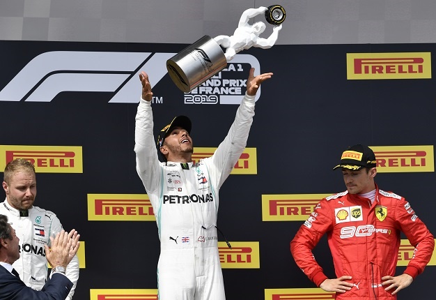 Mercedes British driver Lewis Hamilton (C) celebrates with his trophy on the podium next to second placed Mercedes Finnish driver Valtteri Bottas (L) and third placed Ferrari's Monegasque driver Charles Leclerc (R) after the French GP at the Paul Ricard Circuit in Le Castellet, southern France, on June 23, 2019. Picture: Gerard Julien / AFP)