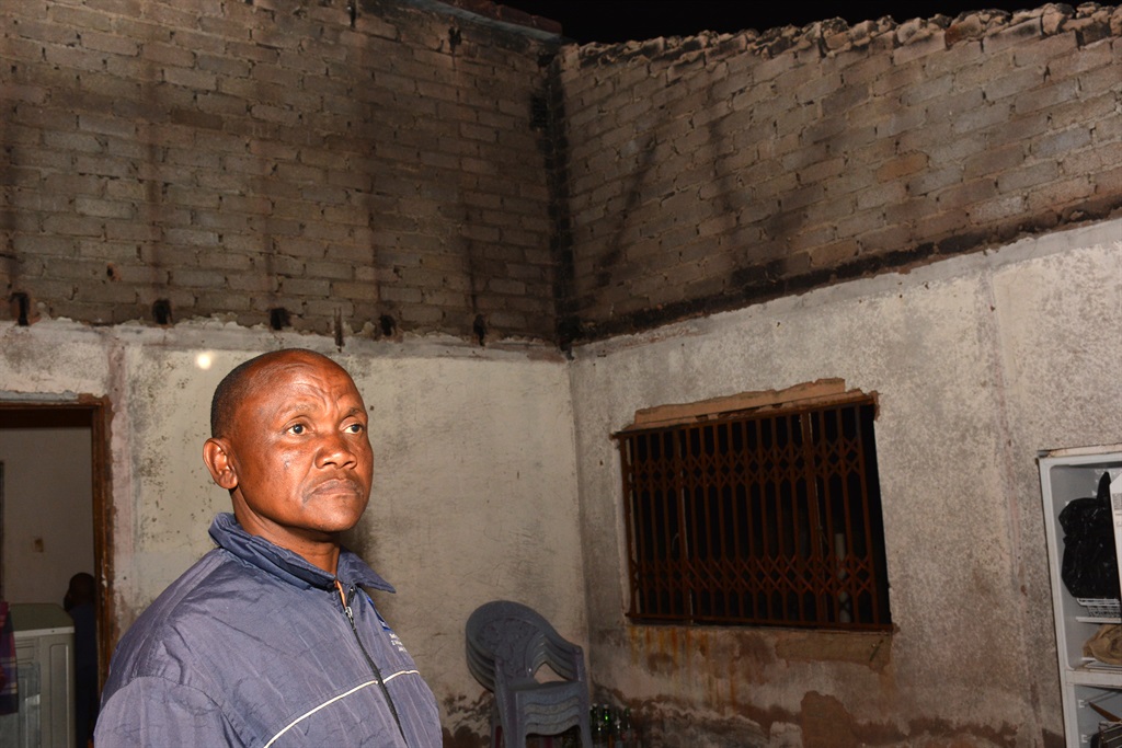 Nicolas Thokwane from Hebron Block E inside his burned garage Photo by Morapedi Mashashe Photo by 