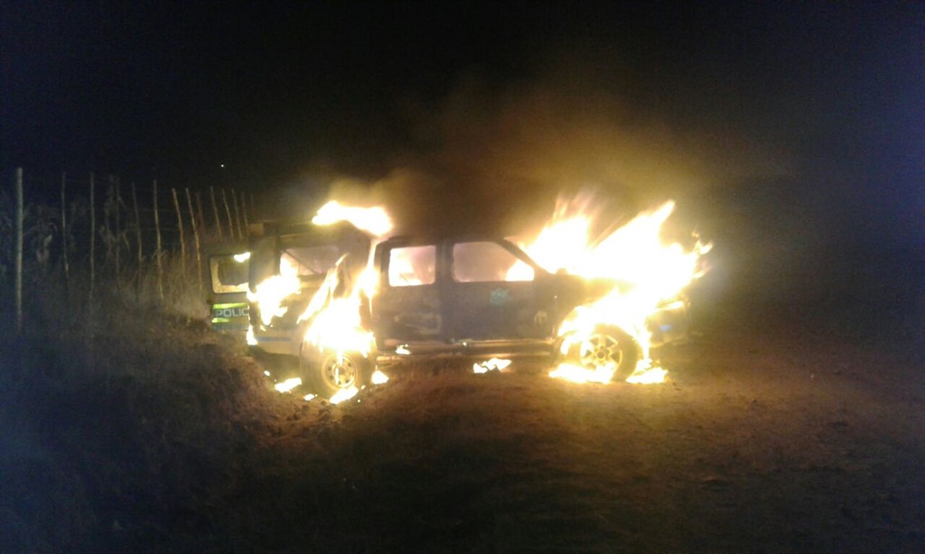 The police van that was torch by community members.