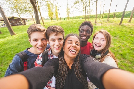 Group of multiethnic teenagers taking a selfie at 