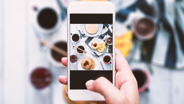 A user instagramming a photo of a breakfast table display.