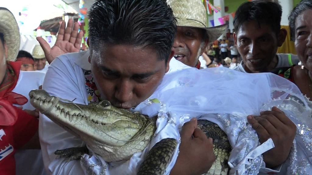 Victor Hugo Sosa, Mayor of San Pedro Huamelula, kisses a spectacled caiman (Caiman crocodilus) called 'La Niña Princesa' ('The Princess Girl') before marrying her in San Pedro Huamelula, Oaxaca state, Mexico.