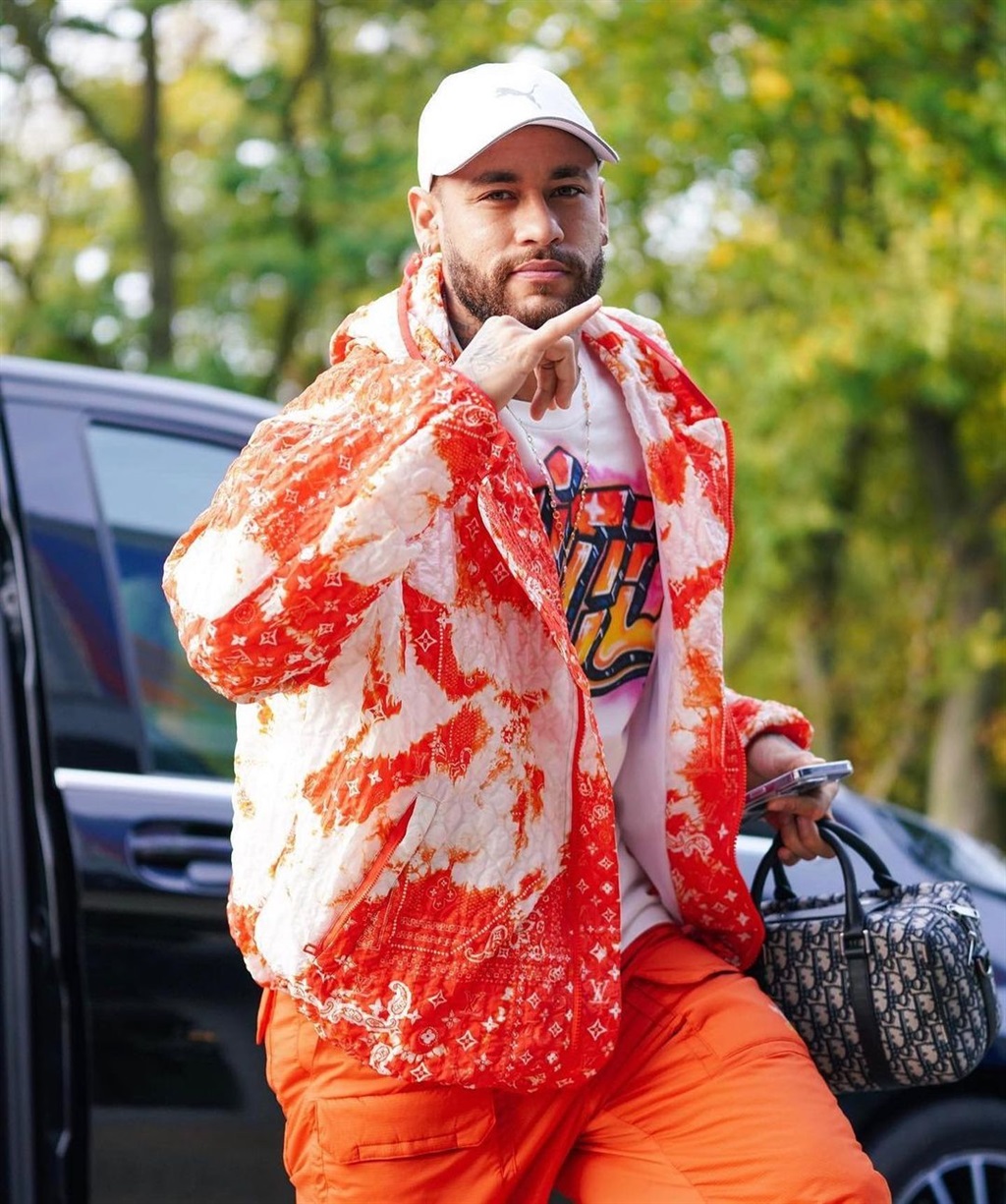 Neymar stepping out in a vibrant orange-filled out