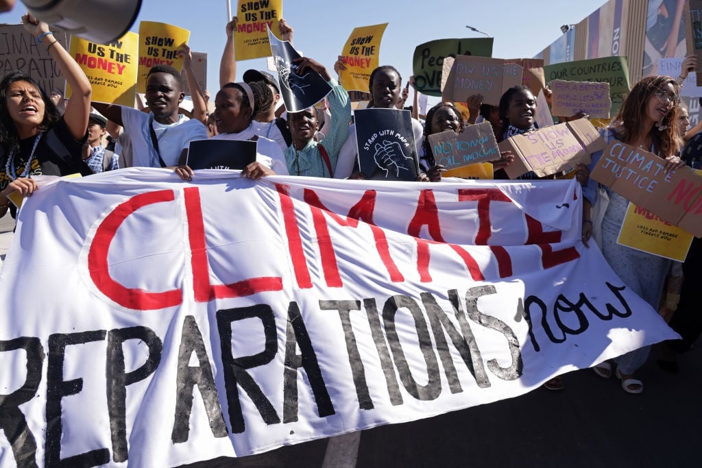 Young protesters demanding climate reparations payment from rich countries to poor countries impacted by climate loss and damage march at the conference venue during the UNFCCC COP27 climate conference on November 11, 2022 in Sharm El Sheikh, Egypt. 