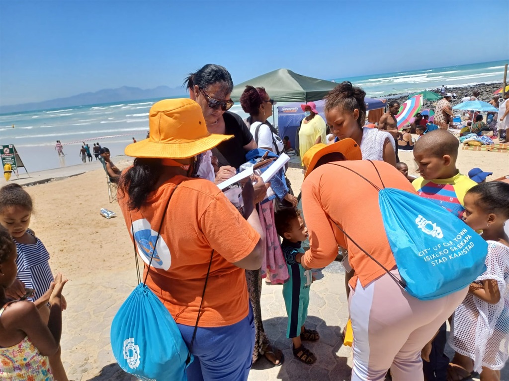 Identikidz staff tagging kids at the Strandfontein Pavilion beach.