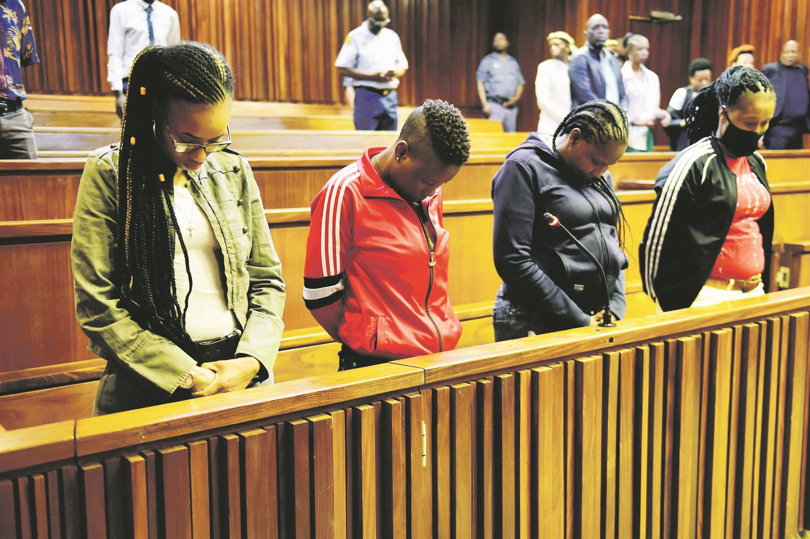 LOOKING DOWN IN SHAME: Tshegofatso Moremane, Gontse Thloele, Margaret Koaile and Portia Mmola are charged in connection with the murder of Prince Lethukuthula Zulu, as well as for theft.            Photo by Christopher Moagi