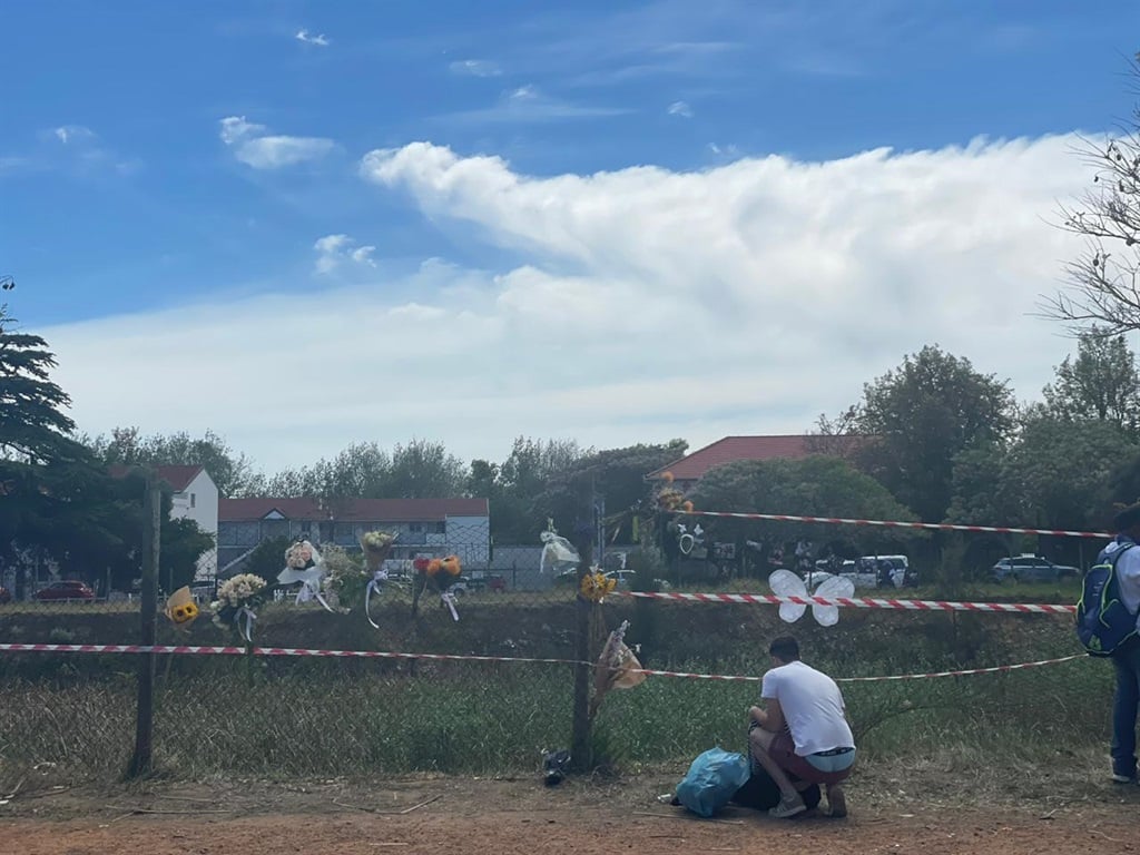 Flowers left at scene where bodies were found