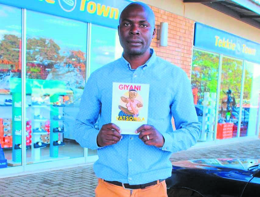Author Hlengani Humphrey Mabasa shows off his poetry book.