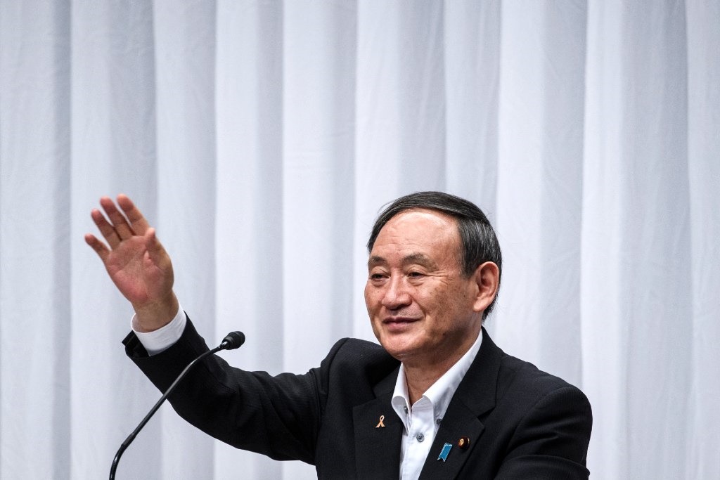 Yoshihide Suga waves following a debate organised by Liberal Democratic Party, Youth Bureau, Women's Bureau at Liberal Democratic Party headquarters in Tokyo on September 9, 2020.