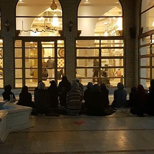 Women pray outside the courtyard of the Gold Mosque in Ormonde.