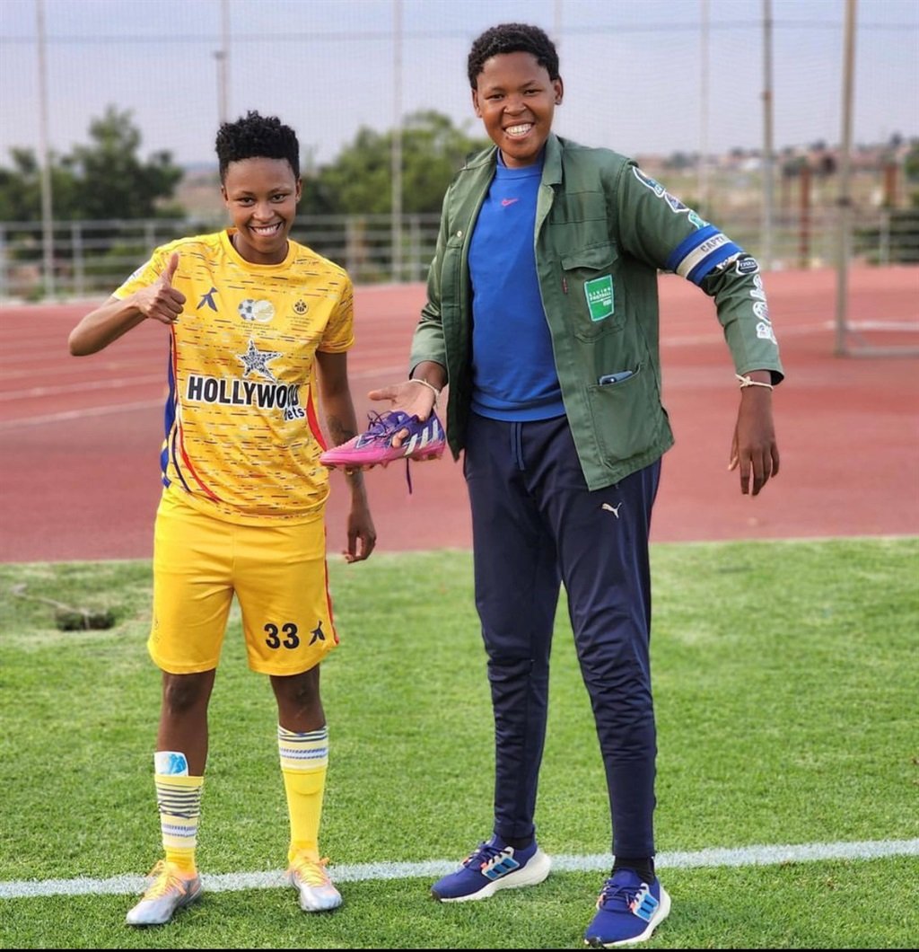 Thato Letsoso alongside Vincent Pitso wearing her new boots.