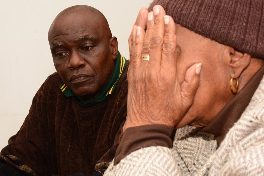 Raymond Mokotong is worried about his mother, Ellen, who is too emotional to show her face.   Photo by Morapedi Mashashe  