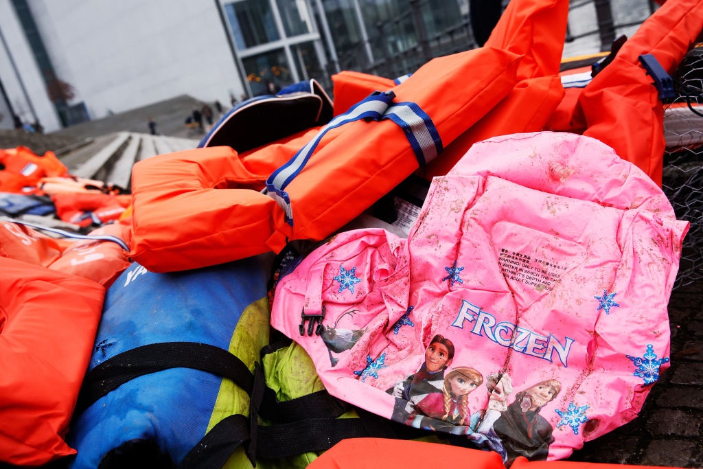 File image:  An installation created by activists next to the Reichstag using 300 life vests originally left behind by migrants on the Greek island of Lesbos in December 2021. (Photo by Carsten Koall/Getty Images)