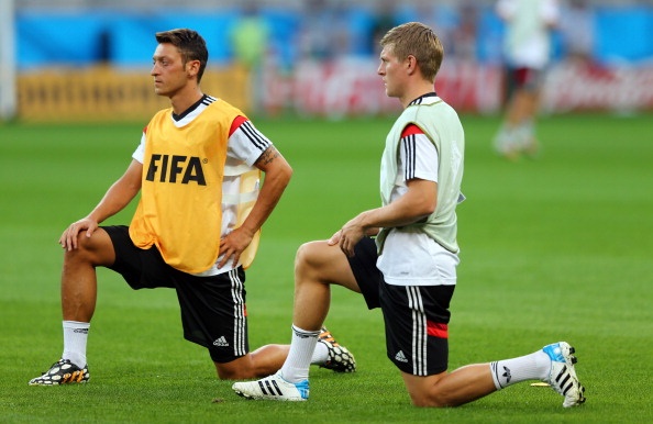  Toni Kroos (R) of Germany stretches during the German national team training 