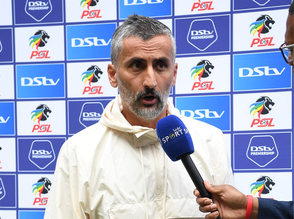 JOHANNESBURG, SOUTH AFRICA - OCTOBER 29: Orlando Pirates coach Jose Riveiro speaks to Mazola Molefe of SABC Sports during the DStv Premiership match between Orlando Pirates and Kaizer Chiefs at FNB Stadium on October 29, 2022 in Johannesburg, South Africa. (Photo by Lefty Shivambu/Gallo Images)