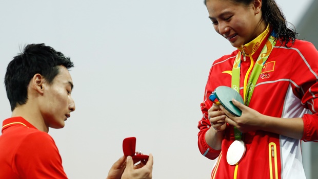 Chinese diver Qin Kai proposes to Olympic silver medalist winner He Zi on the podium during the Rio 2016 Olympic Games