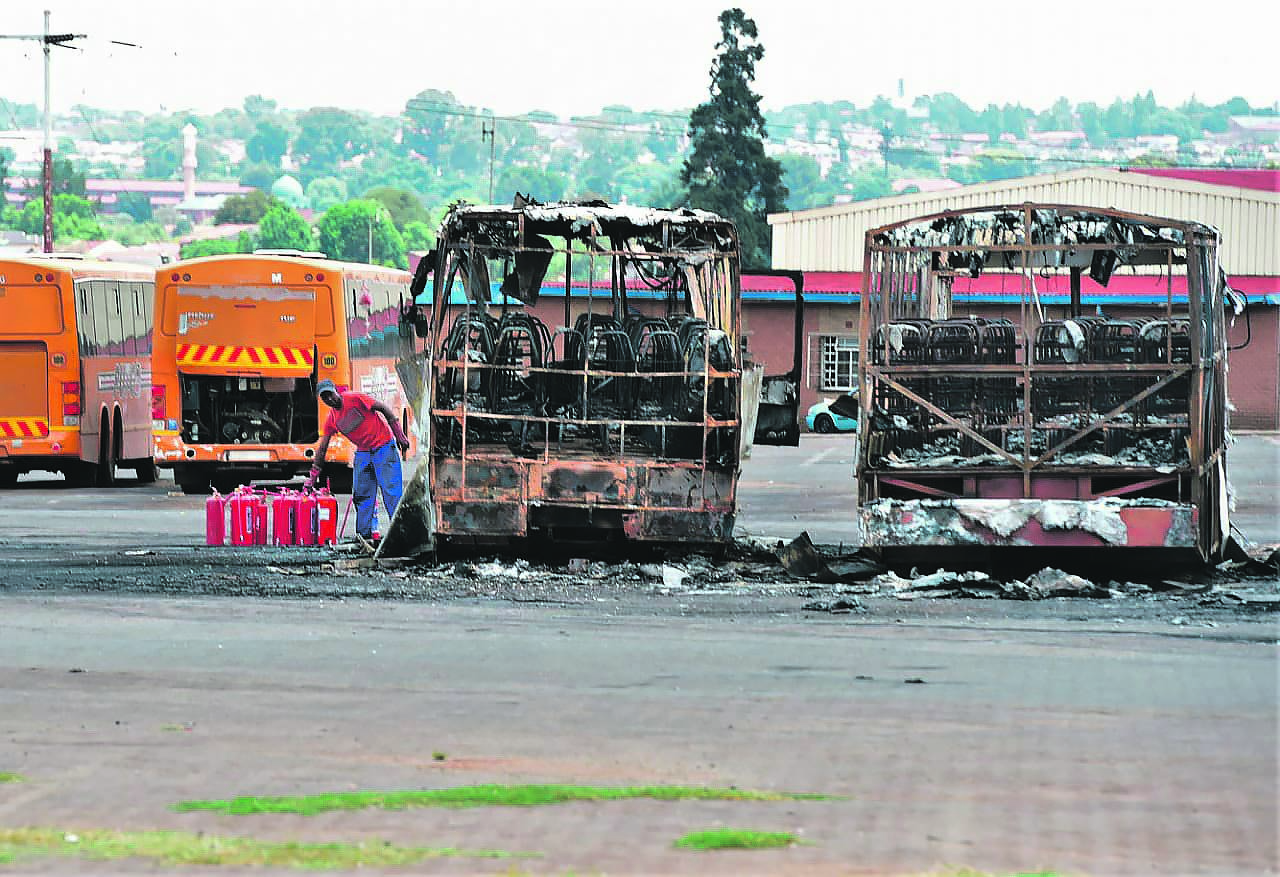 Five Putco buses were left in flames after a group of suspicious men were spotted at the bus depot in Eldorado Park, south of Joburg.    Photo by Morapedi Mashashe
