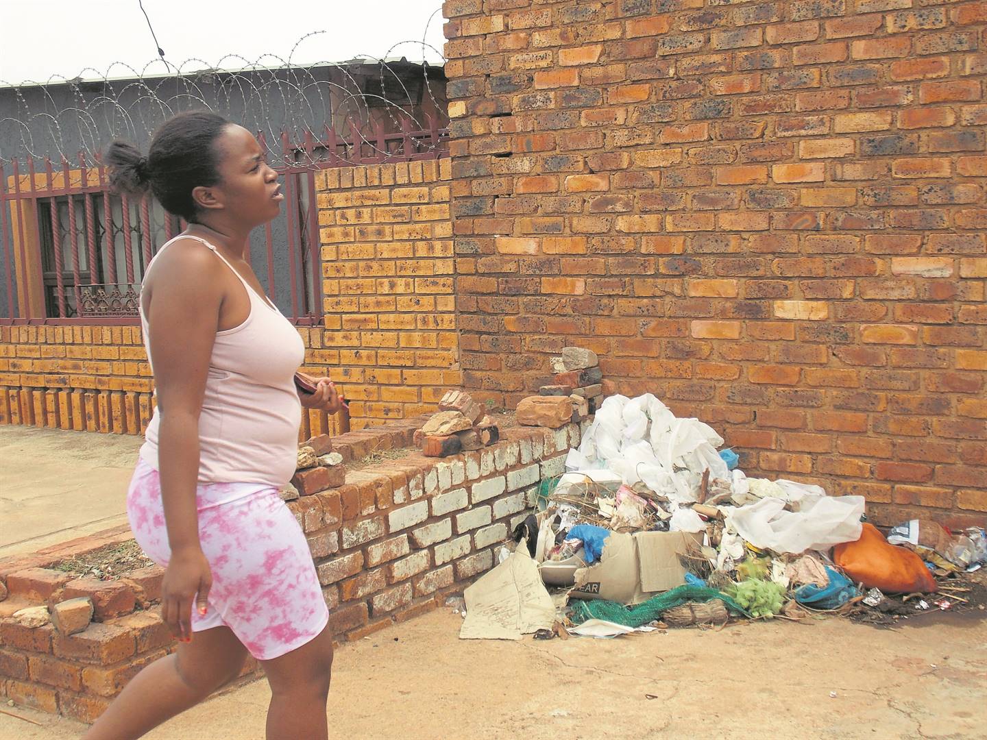 Mmapaseka Makgalwa said last week the workers were cleaning the mortuary and left their rubbish outside the mortuary. The rubbish found its way into their yards in Atteridgeville.        Photo by Aaron Dube