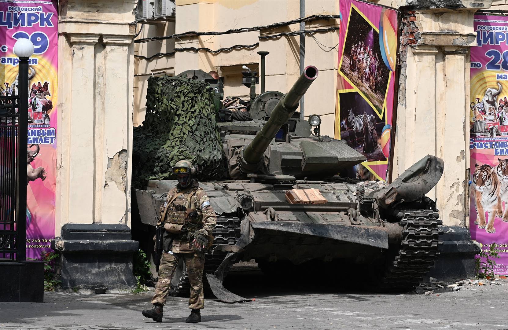 Fighter of the Wagner private mercenary group walks past a tank near a local circus in the city of Rostov-on-Don in Russia, yesterday