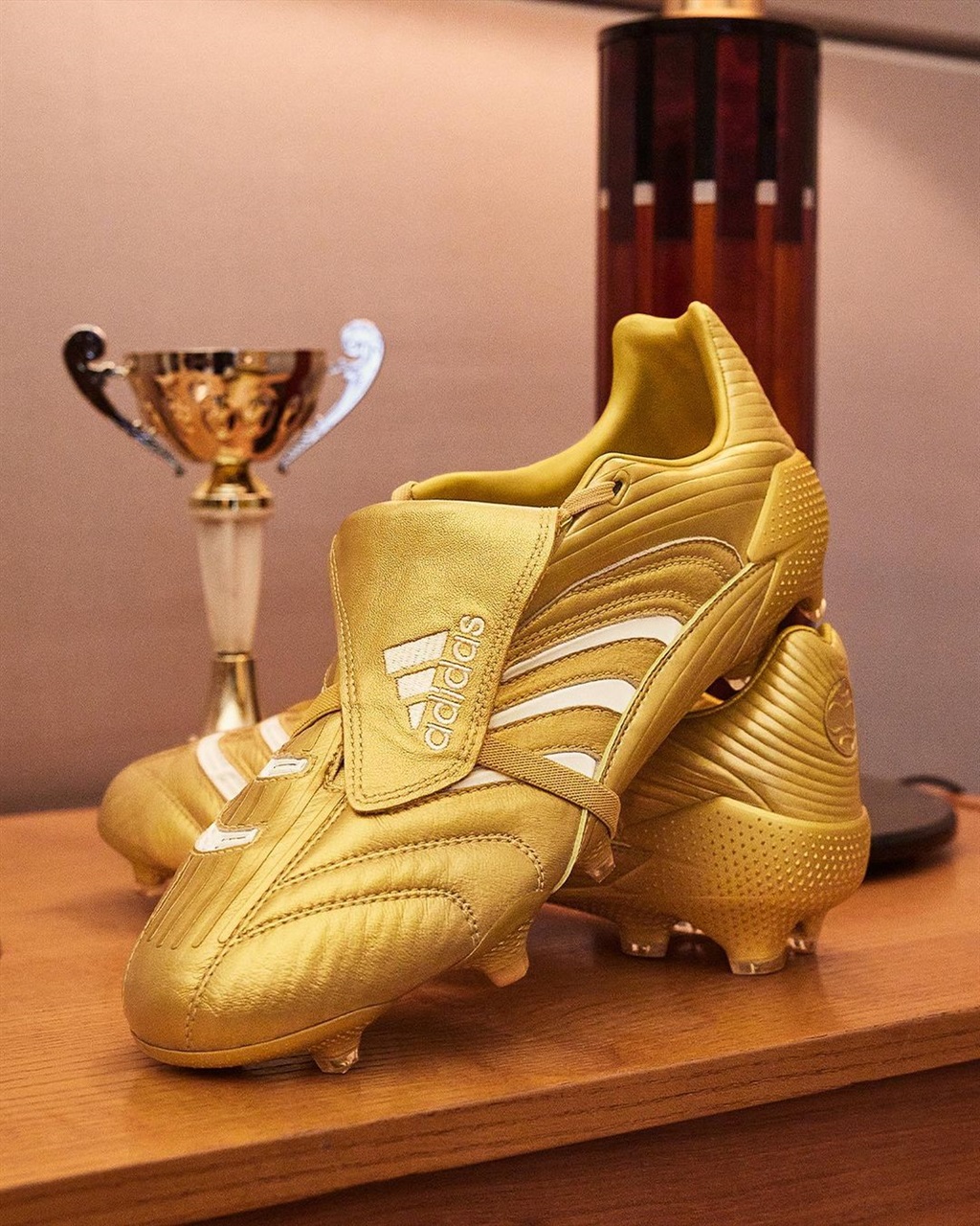 The gold Adidas Predator Absolute boots.