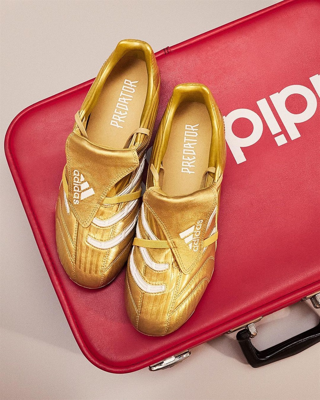 The gold Adidas Predator Absolute boots.