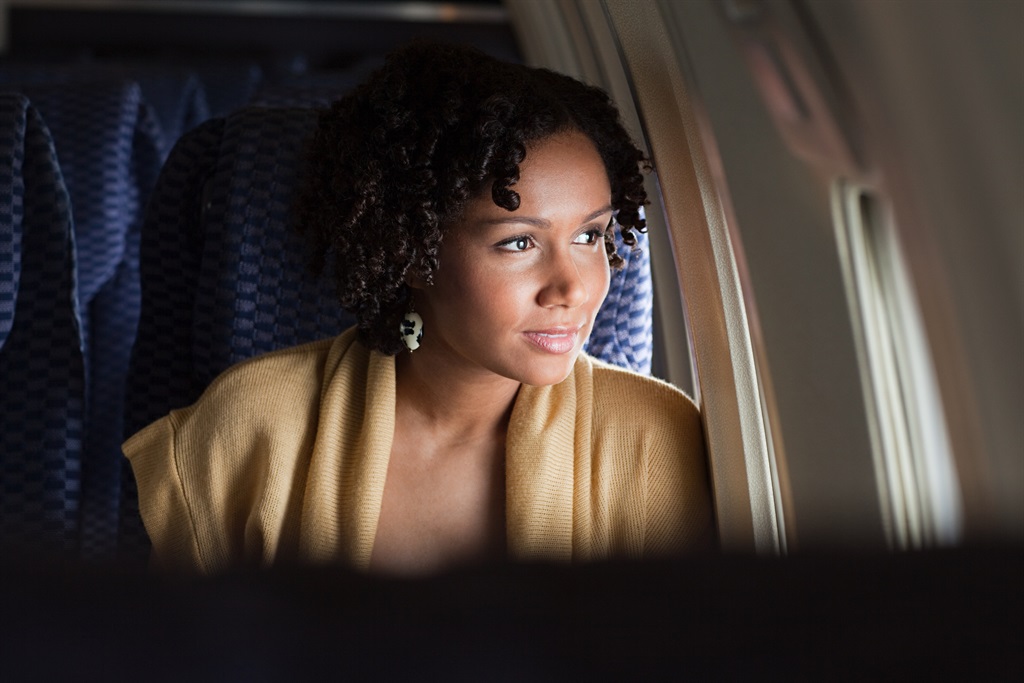 Woman on a flight. (Photo: Getty Images)