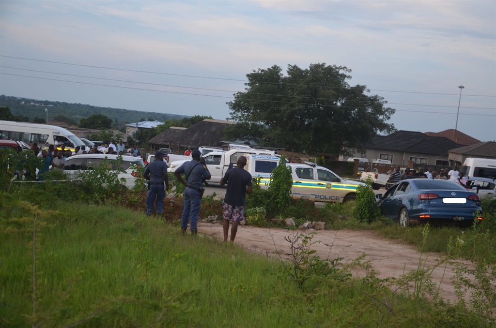 Shocked residents gathered on the side of the road, as police inspected the VW Jetta TSI.
Photo by Oris Mnisi 