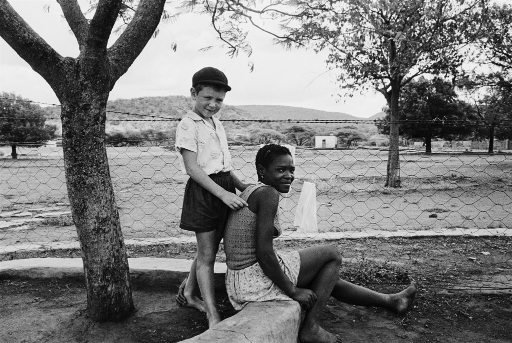 A farmer’s son with his nursemaid, Heimweeberg, Nietverdiend, Western Transvaal, 1964 David Goldblatt was known for climbing into his car and travelling the country to capture what lay beneath the laws introduced by apartheid. His images raise questions rather than give answers. In a time of separate development, why is the ‘kleinbaas’ so attached to his ‘nursemaid’? Were black lives only dignified in the service of whites? Who raises the child raising the child? How will their destinies play out in a brutally unequal society? Picture: David Goldblatt