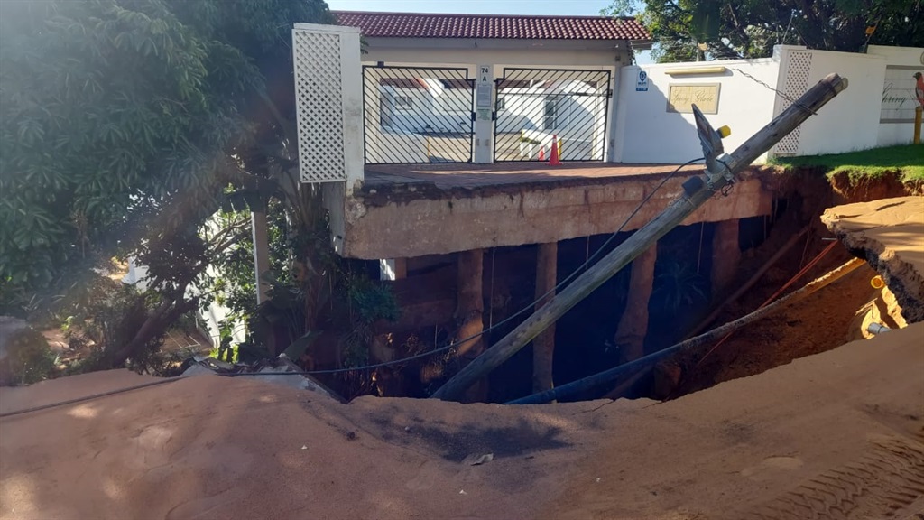 A road in uMhlanga is completely washed away, taking the entrance to an apartment complex with it.