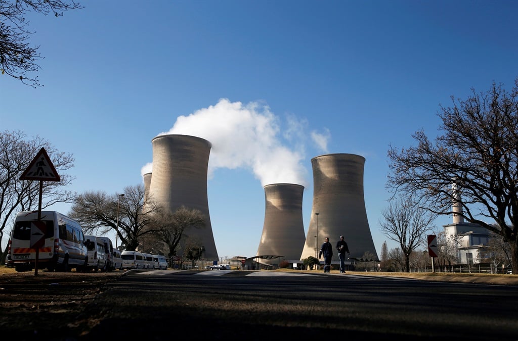 Workers are seen near cooling towers of the Hendrina power station, located south of Middelburg. Picture: Siphiwe Sibeko/Reuters