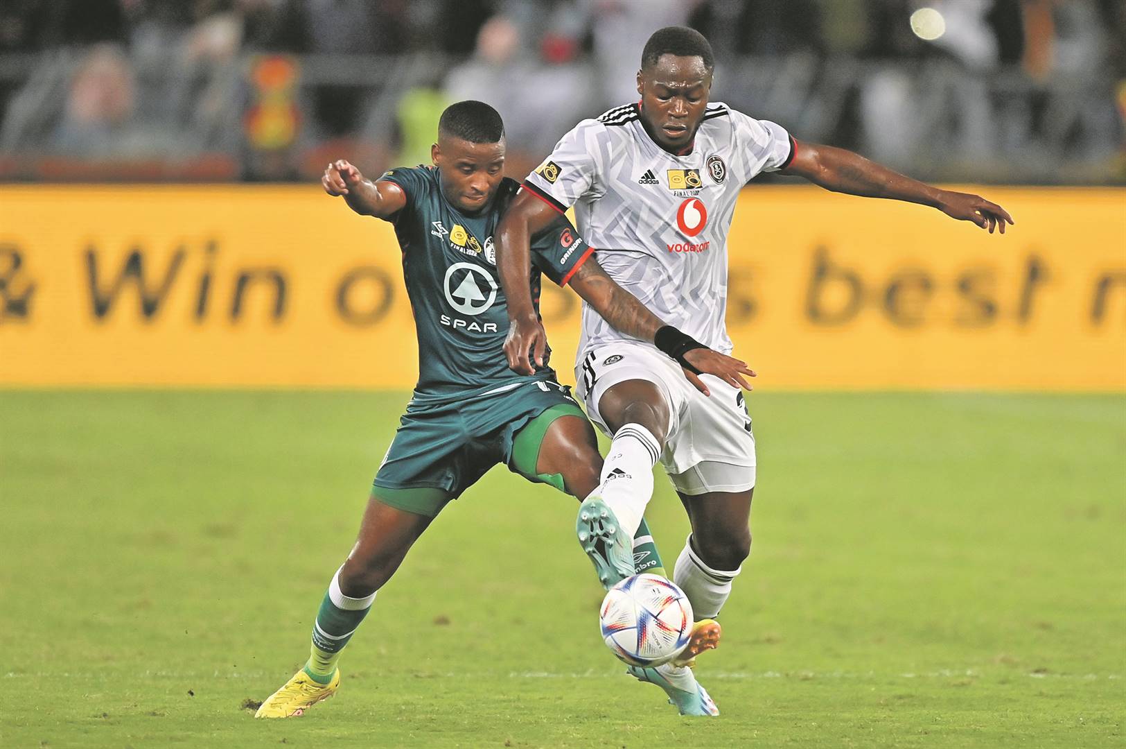 Mbongeni Gumede of AmaZulu in a tussle with Orlando Pirates striker Bienvenu Eva Nga during the MTN8 final at Moses Mabhida Stadium on Saturday. Photo by              BackpagePix