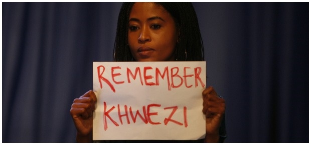 Demonstrator holds #RememberKwezi sign. (Photo: Getty images/Gallo Images)