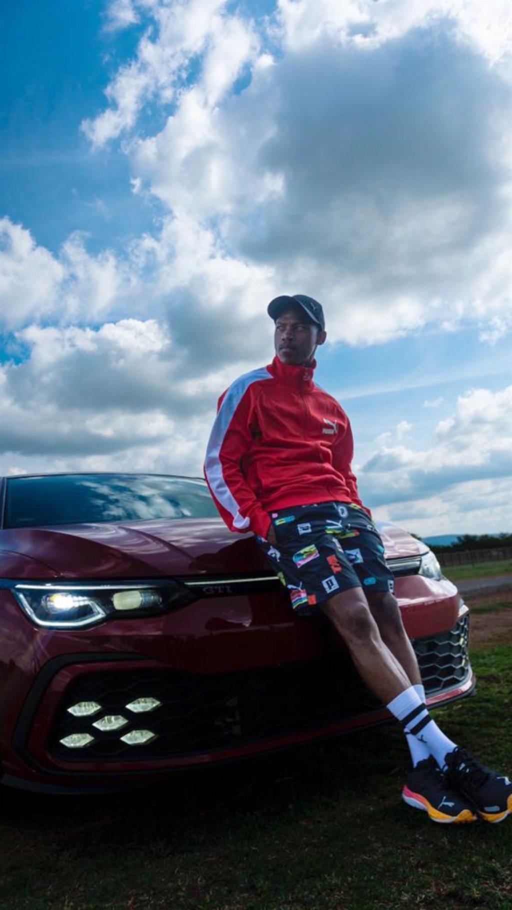 Ashley Du Preez posing alongside his VW Golf 8 GTI