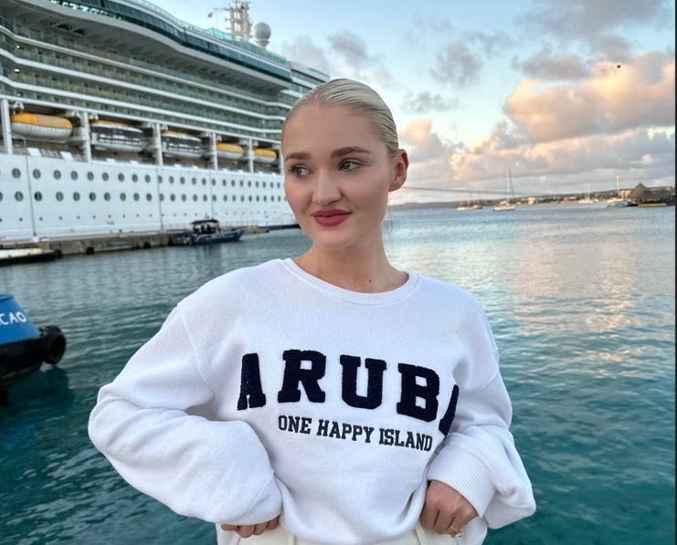 Amike Oosthuizen poses in front of Royal Caribbean’s Ultimate World Cruise.