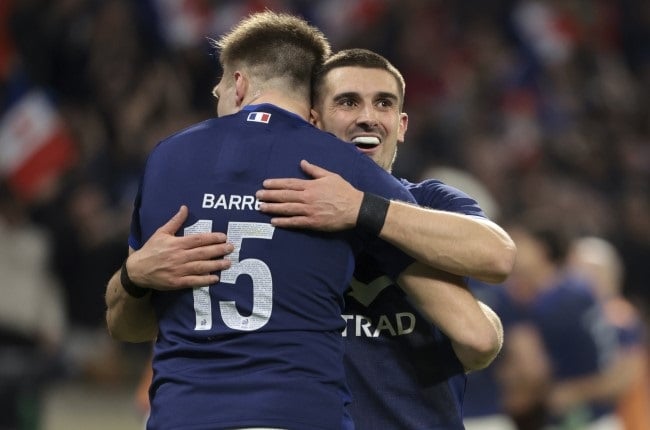France flyhalf Thomas Ramos and teammate Leo Barre celebrate a try scored against England at Groupama Stadium in Lyon on Saturday.(Photo by Jean Catuffe/Getty Images)