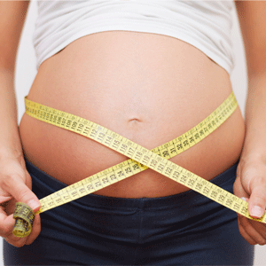 Pregnant woman with measuring tape