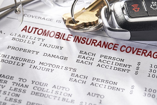 Auto Insurance policy with keys and glasses