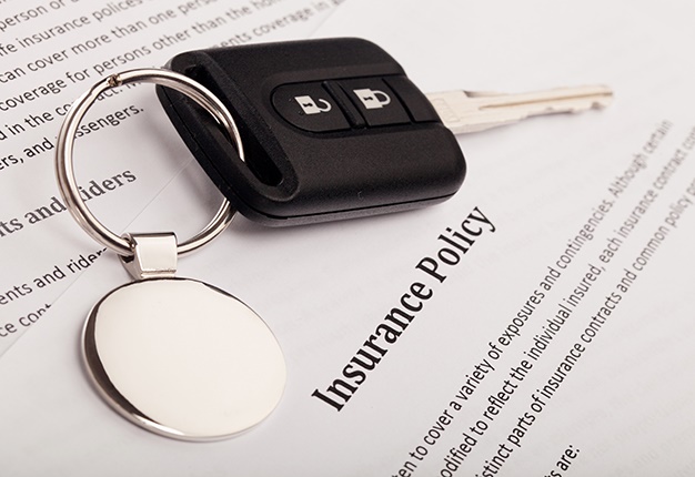 Auto Insurance policy with keys and glasses