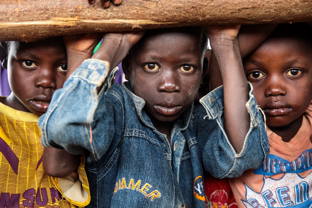 Young refugees from the Democratic Republic of Congo wait to be processed in Kyangwali, Uganda, on April 3 2018 . More than 65,000 people have arrived in Uganda from the Democratic Republic of Congo since the beginning of 2018 as they escape violence in the Ituri province. Picture: Jack Taylor/Getty Images)