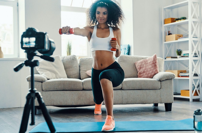 Women filming herself exercising 