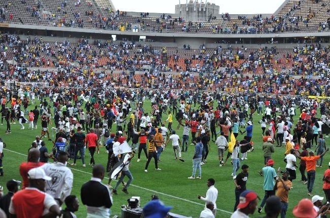 OSupporters storm the pitch follwing Orlando Pirates' win over Mamelodi Sundowns in the second leg of the MTN8 semi-final.