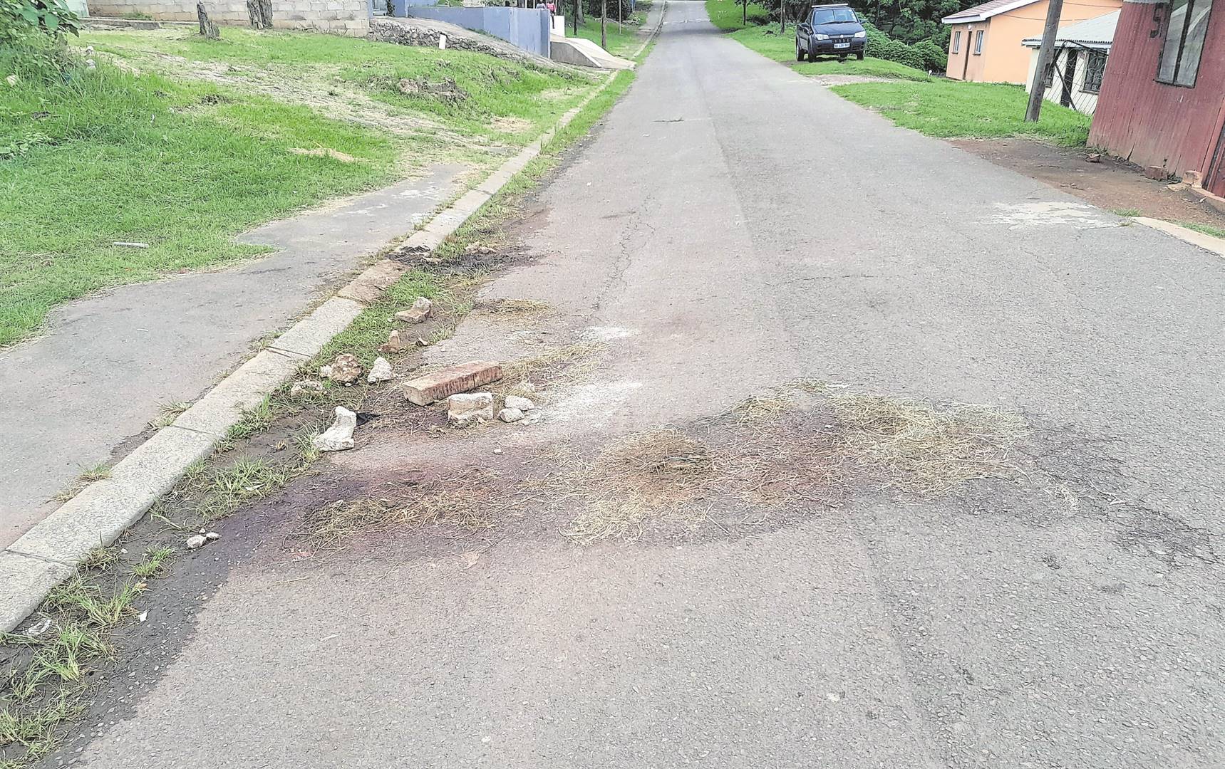 The bloodstains on the road where two men were beaten to death in KwaMashu K section.    Photo by Mbali Dlungwana