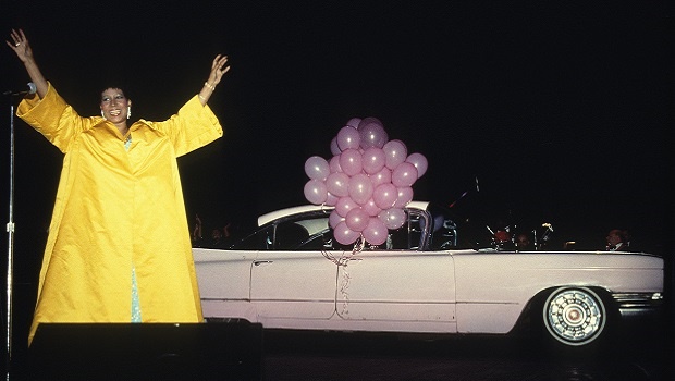 Aretha Franklin in a yellow coat.