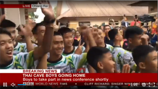 <p>The 12 rescued boys and their coach - all smiles - are now making their way into the press conference venue. (Screenshot: BBC News)</p><p></p>