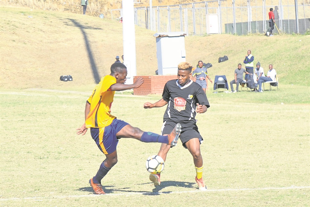 Sgcino Mhlongo of KZN battling with Katlego Ramanyai of Gauteng during the SAB Under-21 National Championships at King Zwelithini Stadium in Umlazi yesterday.Photo byJabulani Langa