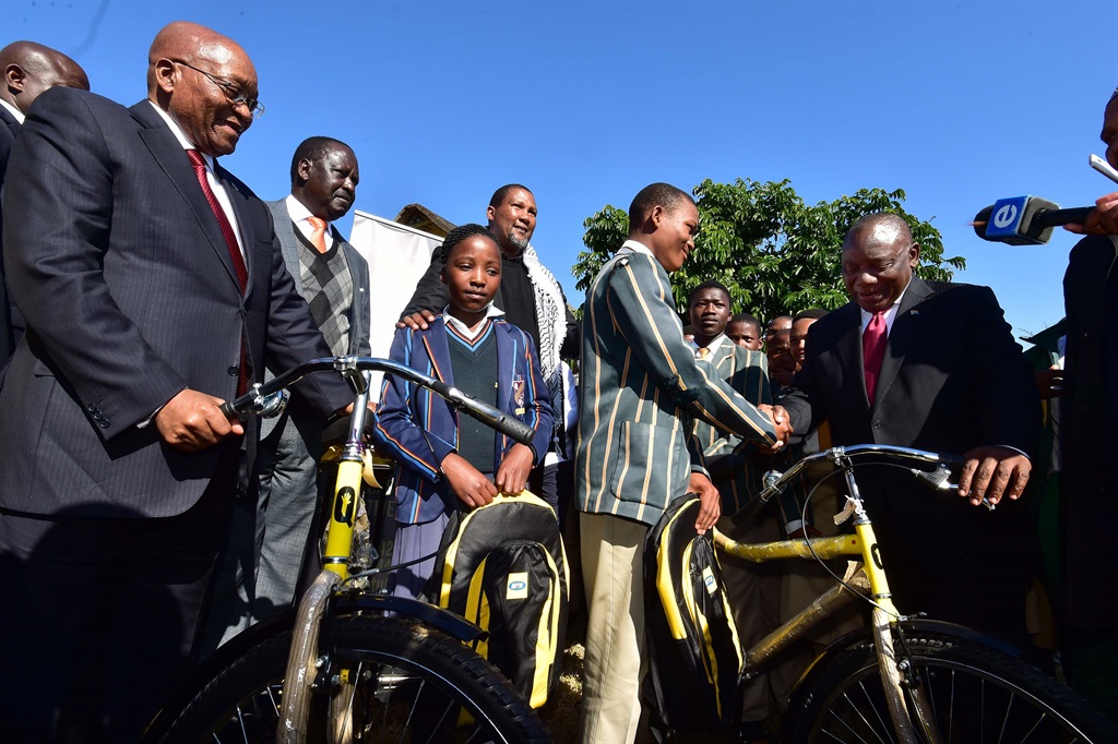 President Cyril Ramaphosa and former President Jacob Zuma hand over bicycles to learners at the birth place of former president Nelson Mandela as part of the centenary celebrations in honour of Madiba at Mvezo in the Eastern Cape Province.